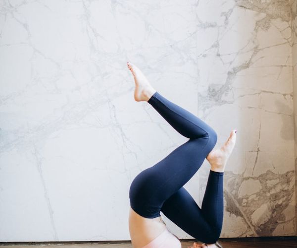 Person doing a powerful yoga pose radiating energy and strength.